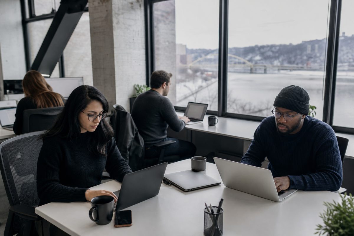 A diverse software team works together in a modern Pittsburgh office.